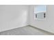 Comfortable bedroom with neutral carpet, a bright window, and ample natural light at 1131 Olivine Ave, Dundee, FL 33838