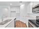 Bright kitchen with stainless steel appliances, including a dishwasher, and ample counter space at 1131 Olivine Ave, Dundee, FL 33838