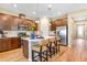 Stylish eat-in kitchen featuring stainless steel appliances, island with bar seating and wood flooring at 1131 Olivine Ave, Dundee, FL 33838