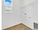 Laundry room with new tile floor and window for natural light at 1131 Olivine Ave, Dundee, FL 33838