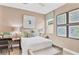 Bright bedroom featuring neutral walls, a bed with decorative pillows, a window and framed blue artwork at 1135 Olivine Ave, Dundee, FL 33838