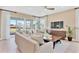 Cozy living room featuring comfortable seating, large windows, neutral decor, and a ceiling fan at 1135 Olivine Ave, Dundee, FL 33838