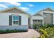 Charming home featuring stone accents, a landscaped yard, and a welcoming walkway to the front door at 1139 Olivine Ave, Dundee, FL 33838