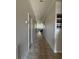 Inviting hallway with tiled floors leading to the living area with natural light; perfect for a welcoming entrance at 12369 Sawgrass Prairie Loop, Orlando, FL 32824