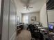 Functional office space with ample desk area, natural light, and shelving for storage, ideal for a productive work environment at 12369 Sawgrass Prairie Loop, Orlando, FL 32824