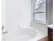 Bright bathroom features a soaking tub with a window for natural light at 12622 Earnest Ave, Orlando, FL 32837