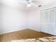 Clean bedroom with hardwood floors has a ceiling fan and closet at 12622 Earnest Ave, Orlando, FL 32837