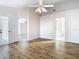 Open bedroom featuring a fan and wood-look flooring at 12622 Earnest Ave, Orlando, FL 32837