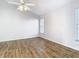 Comfortable bedroom with wood-look floors, fan and natural light at 12622 Earnest Ave, Orlando, FL 32837