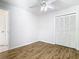 Bright bedroom features new floors, a ceiling fan, and a spacious closet at 12622 Earnest Ave, Orlando, FL 32837