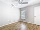 Neutral bedroom features wood floors, a ceiling fan, and a bright window at 12622 Earnest Ave, Orlando, FL 32837