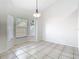 Bright dining area with tiled floors, ample natural light, and modern pendant lighting at 12622 Earnest Ave, Orlando, FL 32837