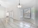 Dining area with tiled floors, large windows, and a decorative pendant light at 12622 Earnest Ave, Orlando, FL 32837