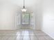 Dining space featuring tile flooring, neutral walls, and a bay window area at 12622 Earnest Ave, Orlando, FL 32837