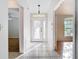 Bright foyer with tile flooring, decorative front door and views into the living spaces of the home at 12622 Earnest Ave, Orlando, FL 32837