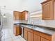 Well-lit kitchen with stainless steel appliances, granite countertops, and window view at 12622 Earnest Ave, Orlando, FL 32837