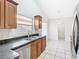 Bright kitchen with granite countertops, stainless steel appliances, and tiled flooring at 12622 Earnest Ave, Orlando, FL 32837