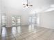 Spacious, bright living room with tile flooring, ceiling fan, and access to the backyard through glass doors at 12622 Earnest Ave, Orlando, FL 32837