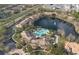 Aerial view of community center, pool, lake, and surrounding residences amid lush landscaping at 1357 Venezia Ct # 302, Davenport, FL 33896