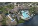 Aerial view of community with pool, bocce ball court, clubhouse and surrounding lake at 1357 Venezia Ct # 302, Davenport, FL 33896