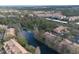 Aerial view of community by lake with lush greenery and walking path at 1357 Venezia Ct # 302, Davenport, FL 33896