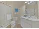 Clean bathroom with glass door shower, white toilet, and sink at 1357 Venezia Ct # 302, Davenport, FL 33896