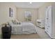 Well-lit bedroom featuring a large bed, a window with blinds, and an armoire at 1357 Venezia Ct # 302, Davenport, FL 33896