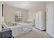 Bright bedroom featuring an armoire, large window with blinds, and a comfortable bed at 1357 Venezia Ct # 302, Davenport, FL 33896