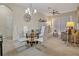 Dining area features a glass table with modern white chairs and chandelier at 1357 Venezia Ct # 302, Davenport, FL 33896