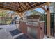 Outdoor kitchen featuring built-in gas grills, countertop space, and metal roof perfect for entertaining at 1357 Venezia Ct # 302, Davenport, FL 33896