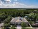 An aerial shot of the community clubhouse, pool, and surrounding greenery at 15147 Driftwood Bend St, Winter Garden, FL 34787