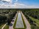 Aerial view of community entrance with water feature, landscaping, and palm trees at 15147 Driftwood Bend St, Winter Garden, FL 34787