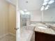 Bright bathroom featuring double sinks with granite counters, a separate shower, and a soaking tub at 15147 Driftwood Bend St, Winter Garden, FL 34787