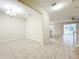 Open concept living room and dining area with tile floors and sliding glass doors to the backyard at 15147 Driftwood Bend St, Winter Garden, FL 34787