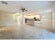 Spacious living room featuring tile floors, a ceiling fan, and an open layout connecting to the kitchen at 15147 Driftwood Bend St, Winter Garden, FL 34787