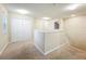 Upstairs loft area with neutral carpet, bright lighting, and stairway access at 15147 Driftwood Bend St, Winter Garden, FL 34787