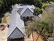 Aerial shot of home with neutral roof, landscaped yard and the entrance arches at 1695 Horseshoe Rd, Enterprise, FL 32725