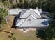 Aerial view of home's roof showing screened-in pool, landscaping, and surrounding nature at 1695 Horseshoe Rd, Enterprise, FL 32725