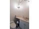 Bright powder room features a single sink vanity, commode, and decorative lighting at 1695 Horseshoe Rd, Enterprise, FL 32725