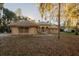 View of the exterior of this single Gathering home with mature tree coverage and barrel tile roof at 1695 Horseshoe Rd, Enterprise, FL 32725