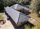 Three-quarter aerial view of a single Gathering home with neutral tile roof at 1695 Horseshoe Rd, Enterprise, FL 32725