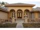 Inviting front entrance with arched windows, double doors, and decorative railing at 1695 Horseshoe Rd, Enterprise, FL 32725