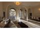 Spacious living room featuring tile floors, elegant chandeliers, and lots of natural light at 1695 Horseshoe Rd, Enterprise, FL 32725