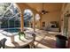 Enclosed patio with a seating area, a pool, and views of the surrounding landscape at 1695 Horseshoe Rd, Enterprise, FL 32725