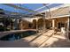 Exterior view of screened-in pool, arched columns, and home's architecture from the deck at 1695 Horseshoe Rd, Enterprise, FL 32725