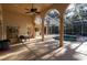 A covered outdoor lounge area featuring a pool surrounded by arched columns and a ceiling fan at 1695 Horseshoe Rd, Enterprise, FL 32725