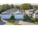 An elevated shot of a lovely home with two-car garage and an inviting brick paved driveway at 1873 Flora Pass Pl, Kissimmee, FL 34747