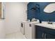 Laundry room with washer, dryer, and utility sink with modern fixtures at 1873 Flora Pass Pl, Kissimmee, FL 34747