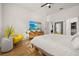 Bright main bedroom with white walls, wood floors, and a modern yellow chair at 1873 Flora Pass Pl, Kissimmee, FL 34747