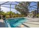 Screened-in pool area featuring a sparkling pool and serene view of the backyard at 1873 Flora Pass Pl, Kissimmee, FL 34747